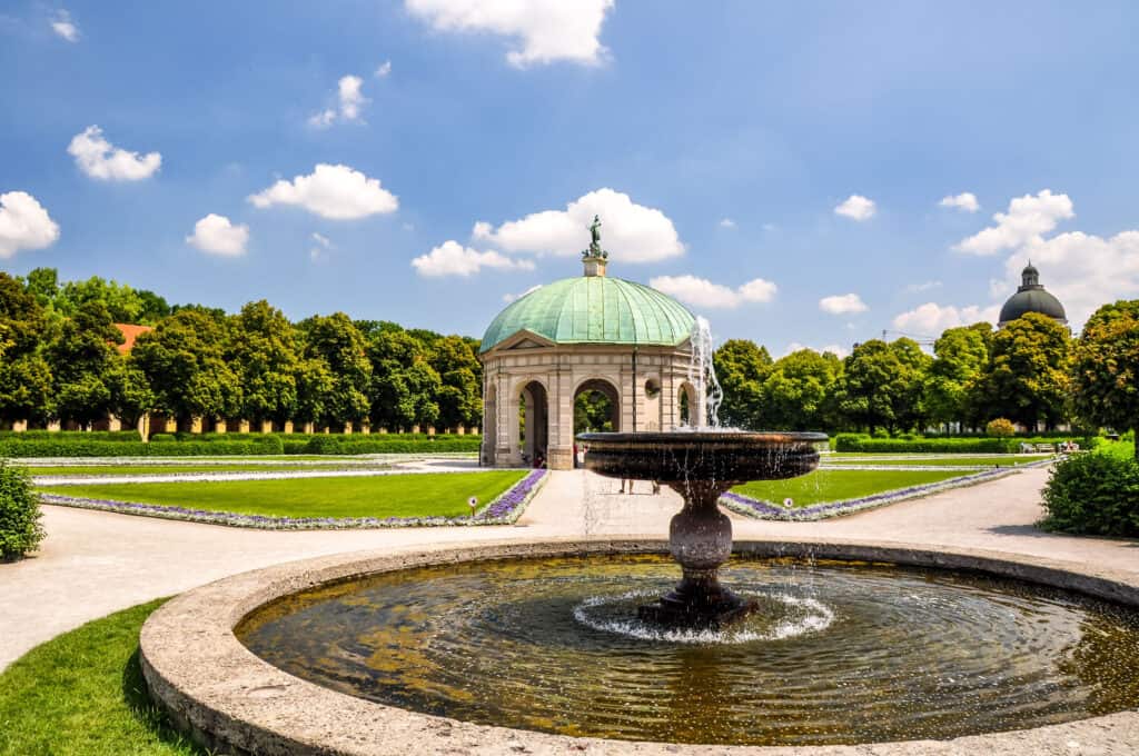 Englischer Garten in Munich, a vast green oasis with serene waterways and sunbathers.
