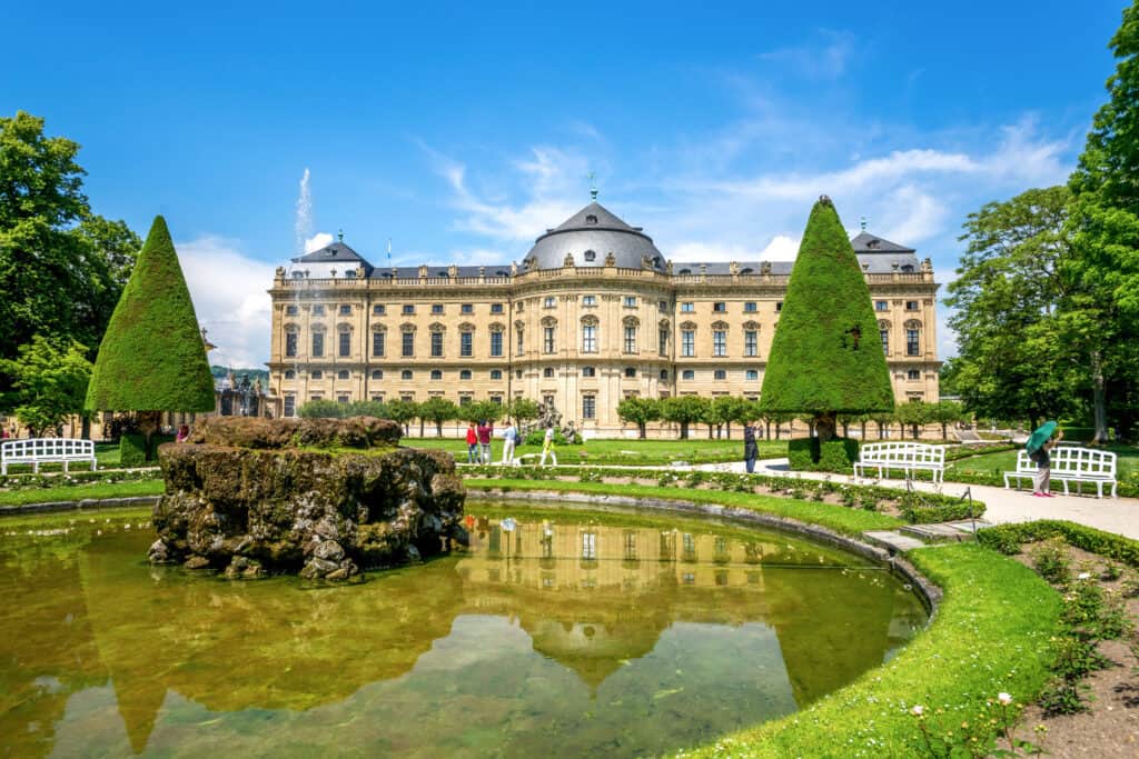 Admire the Würzburg Residence's front facade, framed by a beautiful garden.