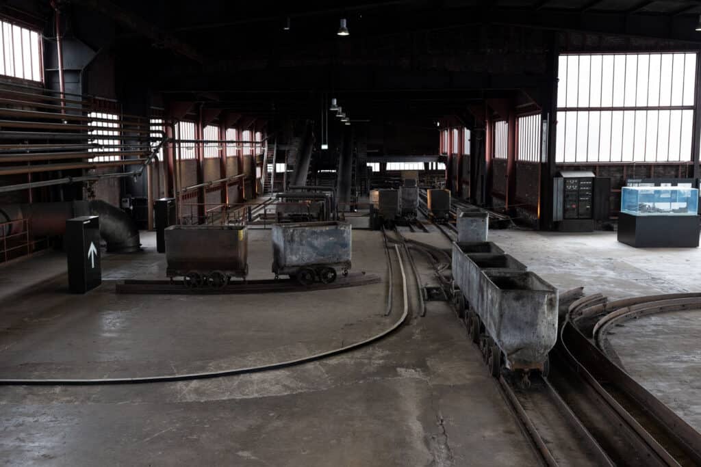 Interior of Zollverein Coal Mine in Essen with original coal carts on tracks.