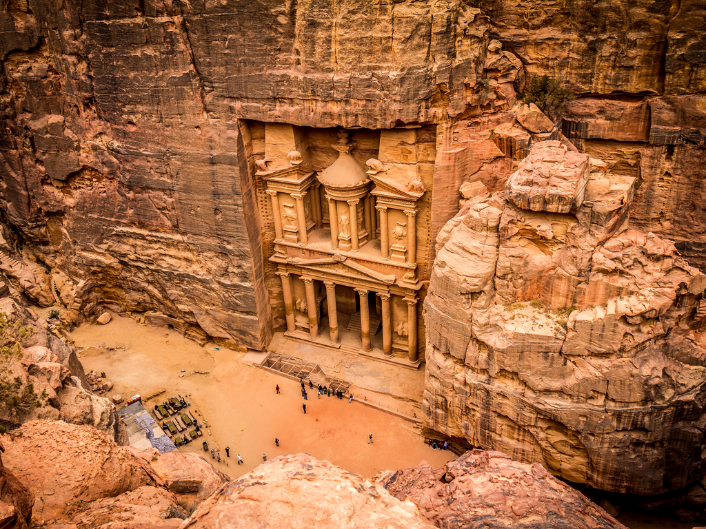 Aerial view of the Monastery (Ad Deir) in Petra, showcasing its large facade carved into the pink sandstone