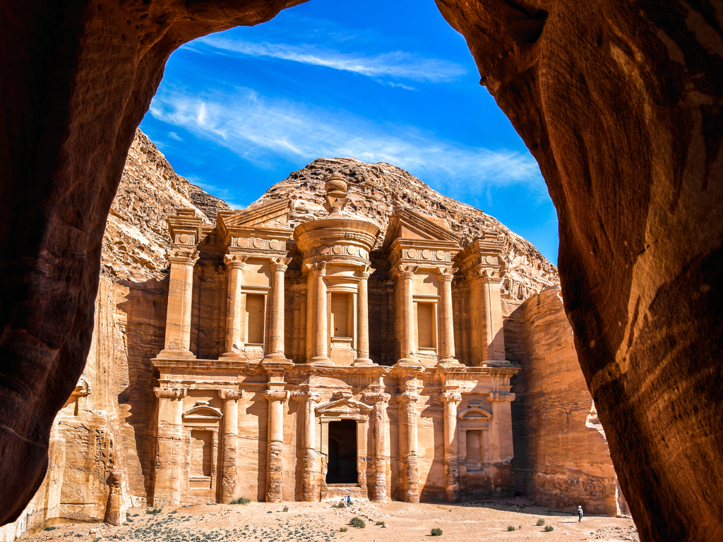 Ancient tombs and houses carved into the pink cliffs of Petra, reflecting the Nabatean engineering skills