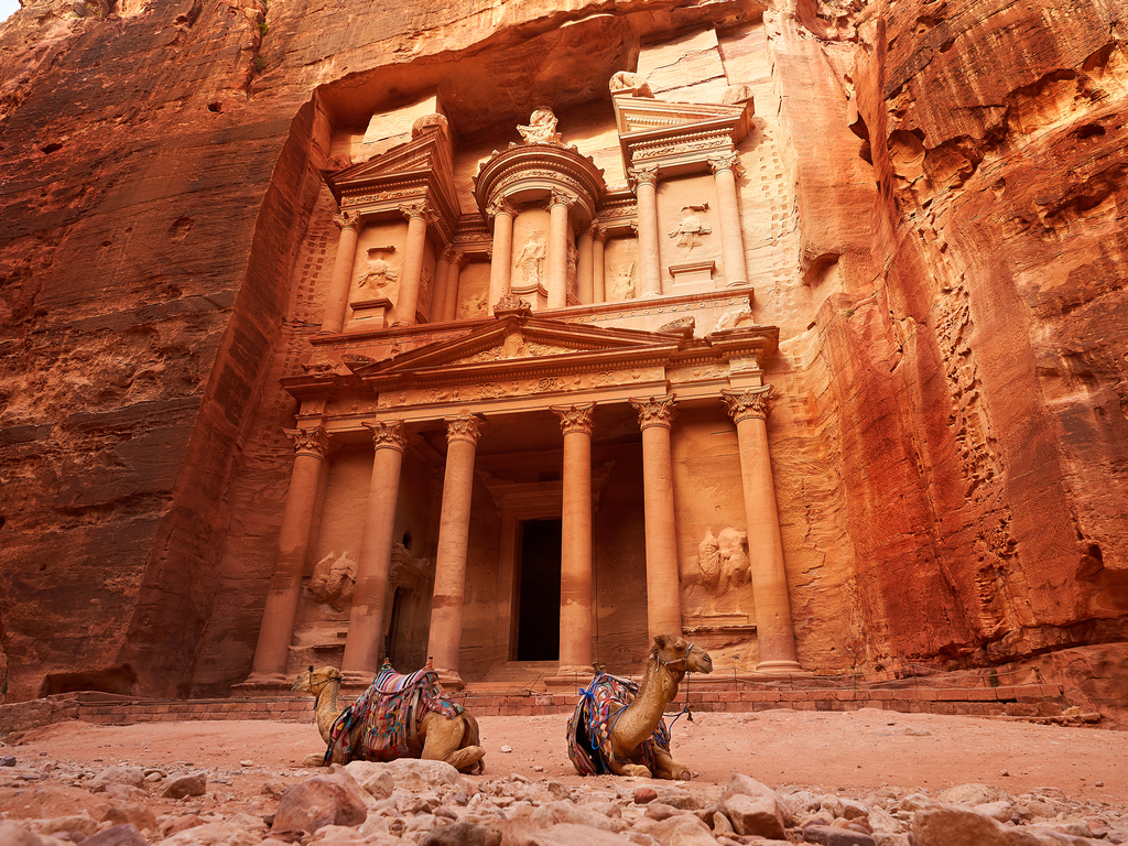 The ancient Al-Khazneh (The Treasury) in Petra, Jordan, seen through the narrow canyon of Al-Siq