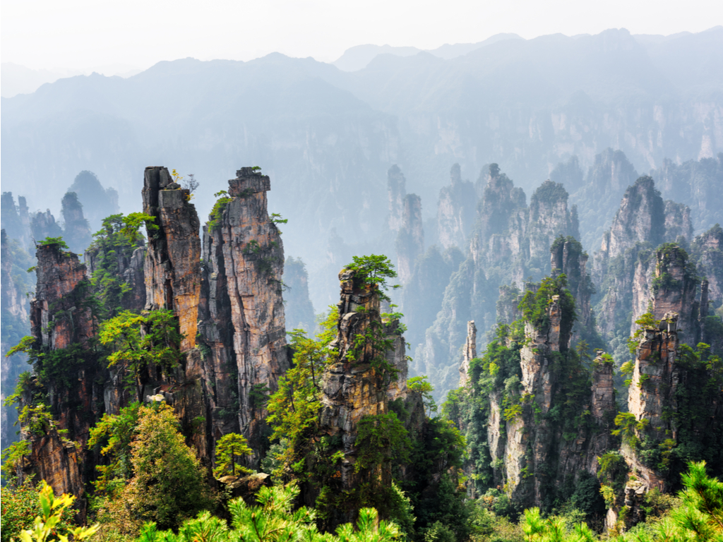 Aerial view of the lush, green valleys and sandstone formations of Tianzi Mountains in the Wulingyuan area