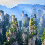 "Spectacular view of the Tianzi Mountains in Zhangjiajie, with towering sandstone pillars rising from the dense forest