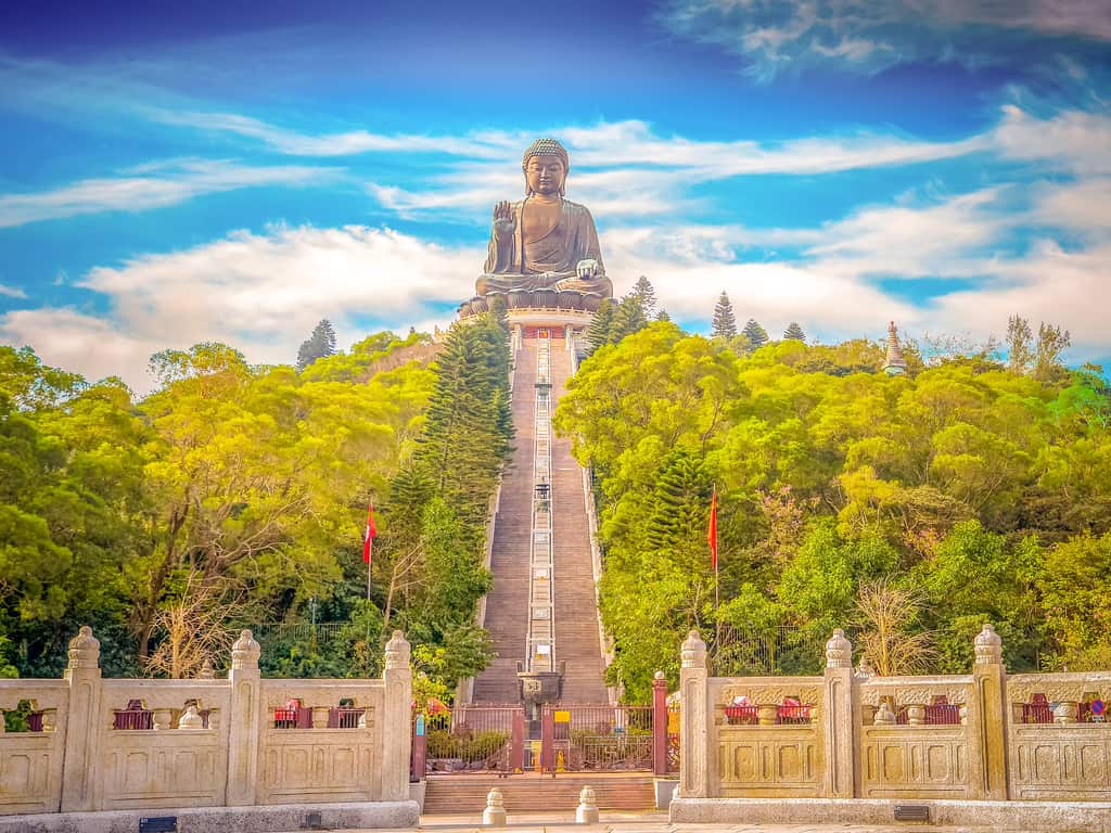 Pilgrims ascending the 268 steps to visit the majestic Tian Tan Buddha, symbolizing the path to enlightenment."