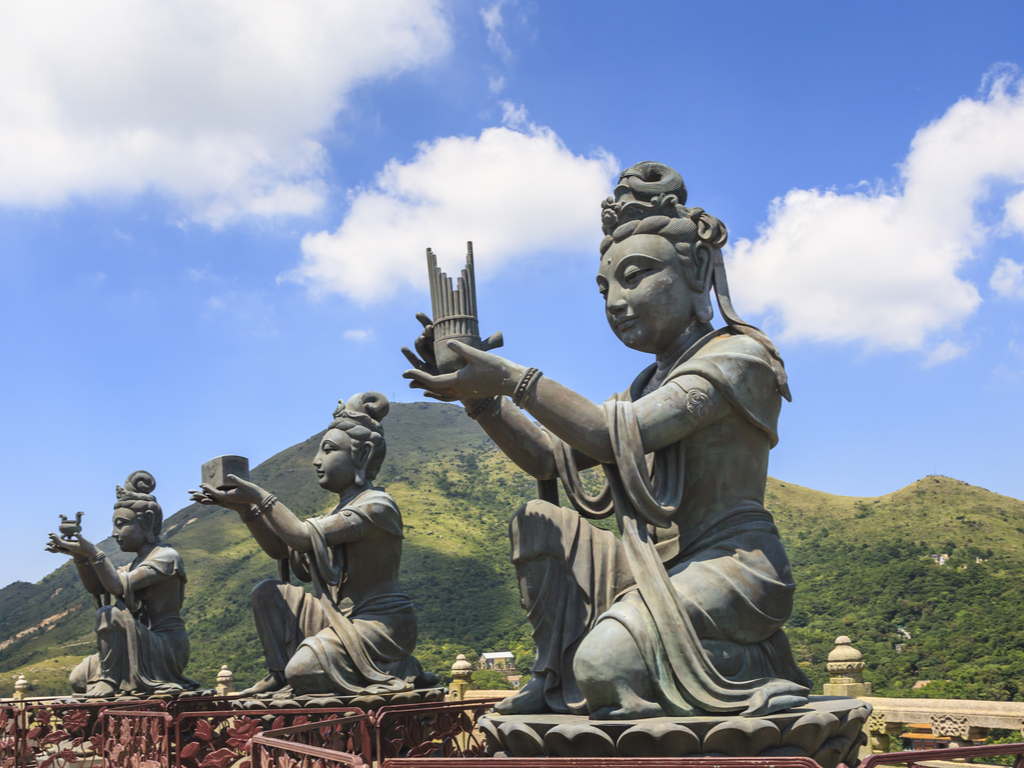he six Devas offering gifts to the Tian Tan Buddha, representing different aspects of Buddhism.