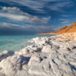 Crystalline formations of salt along the shores of the Dead Sea, reflecting the intense sunlight