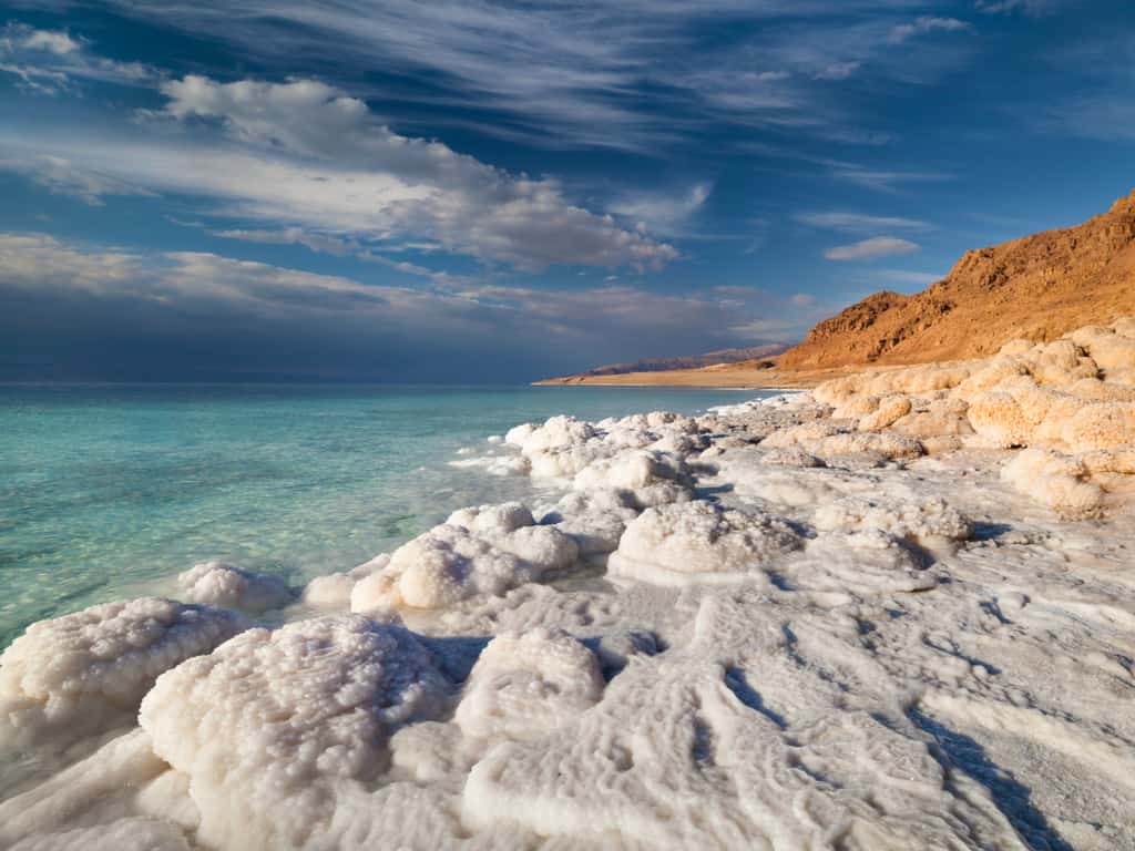 Crystalline formations of salt along the shores of the Dead Sea, reflecting the intense sunlight