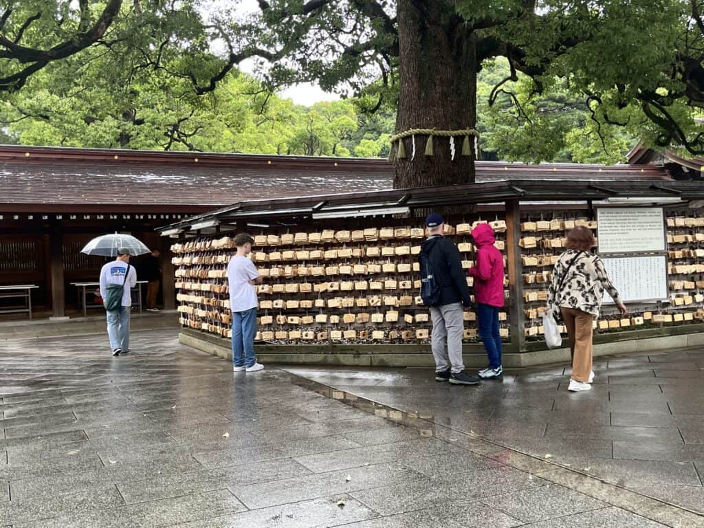 Close-up of ema wooden plaques at Meiji Shrine, with handwritten wishes and prayers in various languages