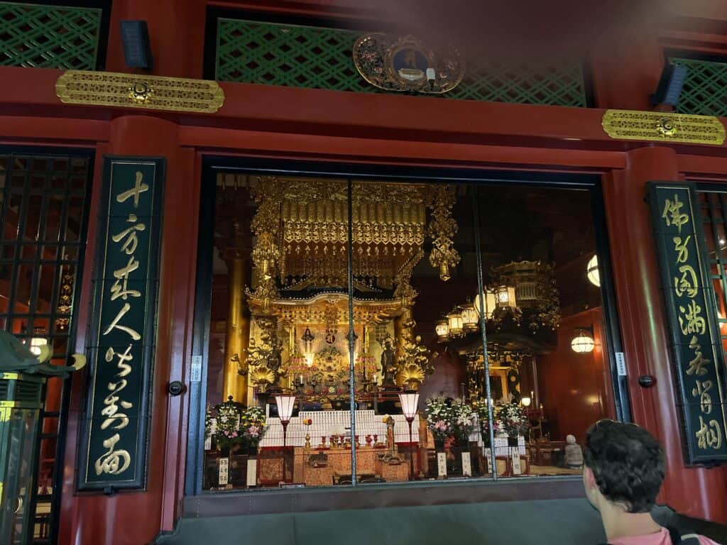 Gleaming golden details of Asakusa Shrine with intricate carvings and traditional Japanese architecture in Tokyo, Japan.