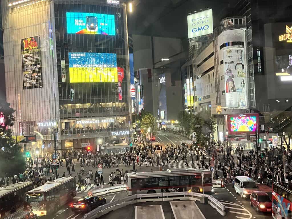 Aerial view of the famous Shibuya Crossing swarmed with pedestrians during rush hour in Tokyo, Japan.