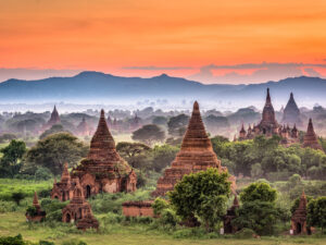 Aerial view of Bagan during sunset, highlighting the golden hues on the temples and landscape.