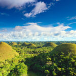 Panoramic view of the Chocolate Hills in Bohol, Philippines, showcasing their distinctive conical shapes