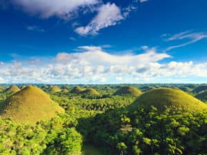 Panoramic view of the Chocolate Hills in Bohol, Philippines, showcasing their distinctive conical shapes