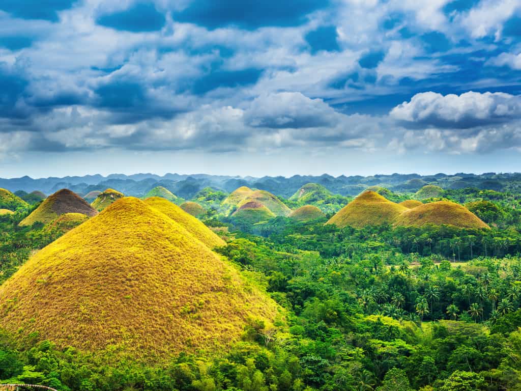 Aerial view of the Chocolate Hills, revealing their extensive spread across the Bohol landscape.