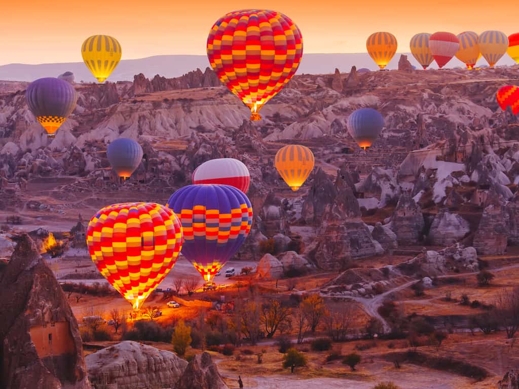 Hot air balloons floating over the unique rock formations of Cappadocia, Turkey