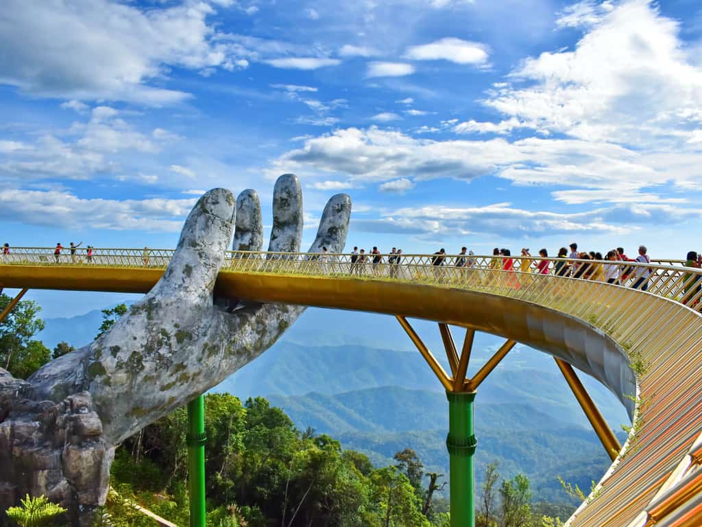 Aerial view of the Golden Bridge and its lush green mountainous backdrop in Vietnam.