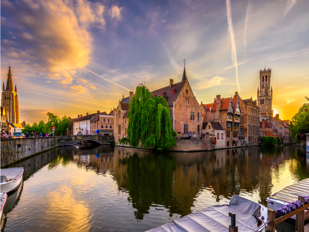 Canal lined with traditional Flemish buildings in Brugge, reflecting Belgium's classic architecture and serene waterways