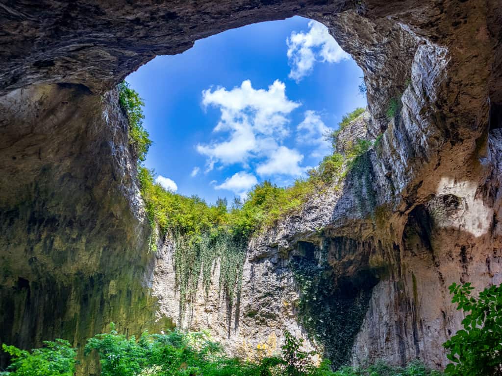 The Devetashka Cave's unique skylight openings, allowing sunlight to illuminate the cave's interior