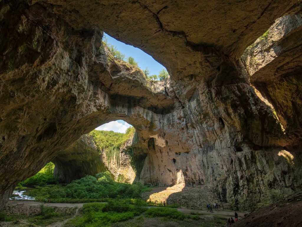 Stunning view from inside Devetashka Cave looking out to the bright outside world, a contrast of light and shadow