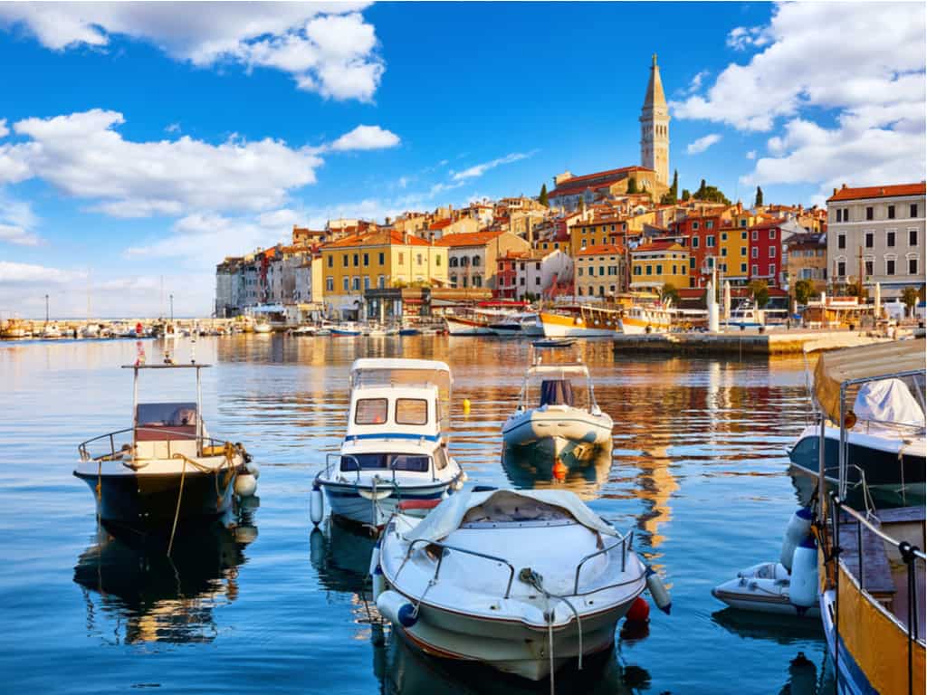 The picturesque harbor of Rovinj with fishing boats and the old town in the background, Istria, Croatia.