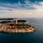 Aerial view of Rovinj, Istria, revealing the peninsula’s shape and the Adriatic Sea's crystal-clear waters.