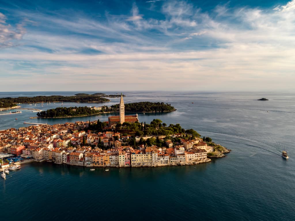 Aerial view of Rovinj, Istria, revealing the peninsula’s shape and the Adriatic Sea's crystal-clear waters.