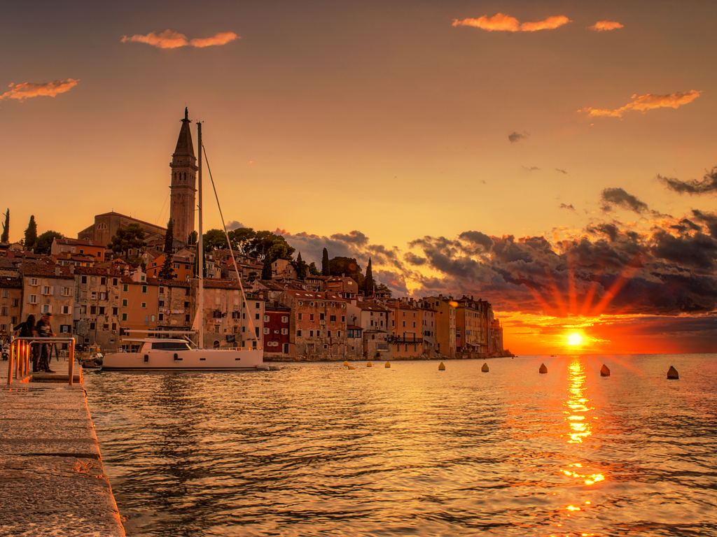 "Night lights reflecting on the water in Rovinj’s harbor, creating a romantic and peaceful evening ambiance.