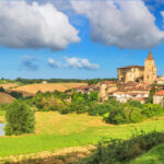 Scenic summer view of Lavardens village in Gascony, Occitanie region, southwestern France, showcasing traditional architecture and lush greenery.