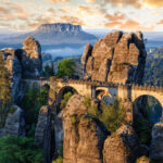 Aerial view of Bastei Bridge amidst the rugged terrain, inviting visitors to explore its majestic beauty