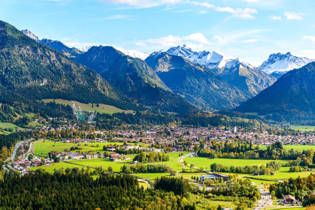 Panoramic view of Oberstdorf in Allgäu, with the fog-laden Nebelhorn mountains of Bavaria, Germany, and the Great Klottenkopf of the Tyrolean Alps in Austria in the background.