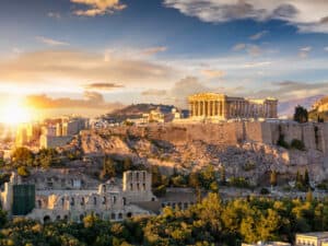 Sunset casting a golden hue on the ancient stones of the Acropolis, creating a magical atmosphere