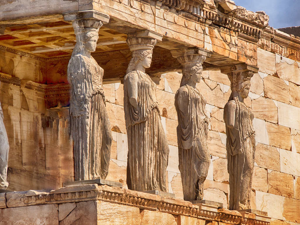 Close-up of the intricate friezes and sculptures on the Parthenon, displaying ancient Greek artistry.