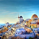 Iconic view of Oia with its white-washed buildings and blue-domed churches overlooking the Aegean Sea.