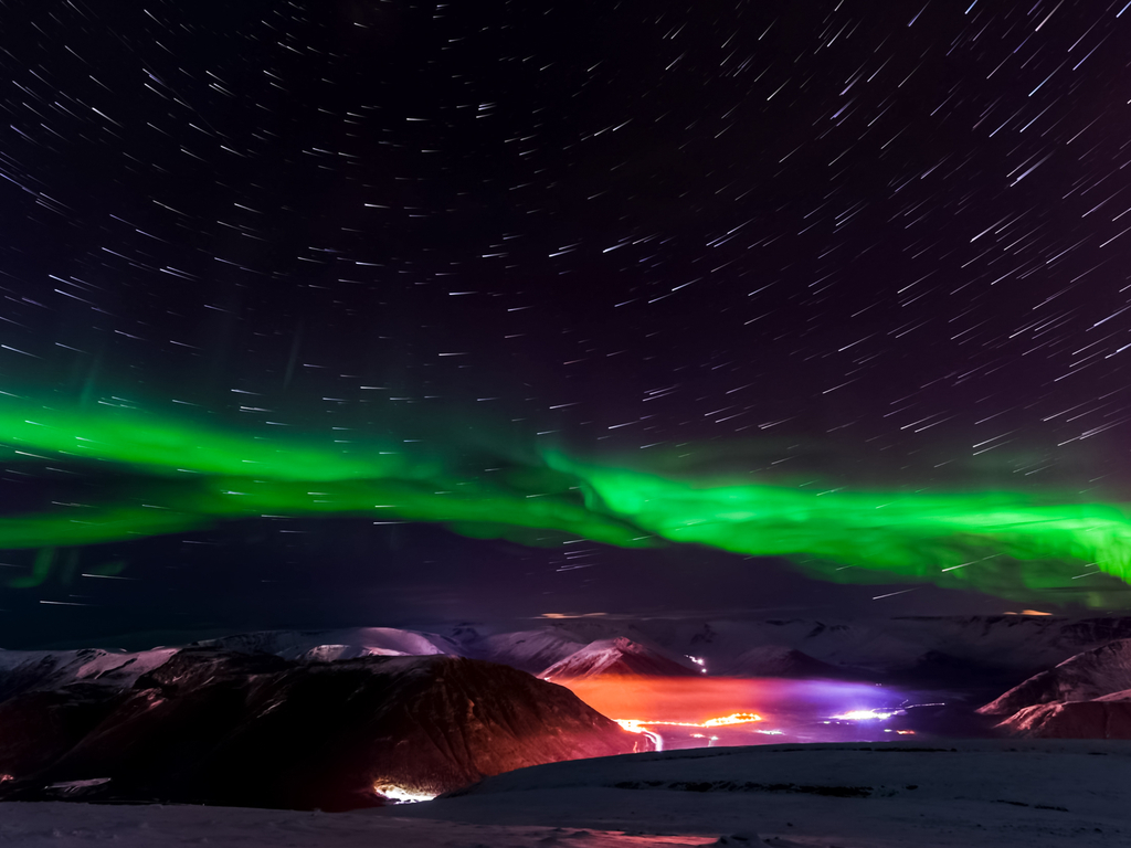 The Aurora Borealis illuminating the night sky over Kirkjufell mountain in Iceland.