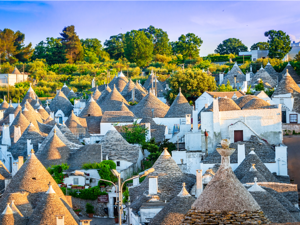 A panoramic view of Alberobello, showcasing the conical roofs and whitewashed walls of its trulli.