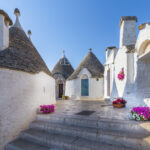 he picturesque streets of Alberobello, Italy, lined with traditional trulli houses.