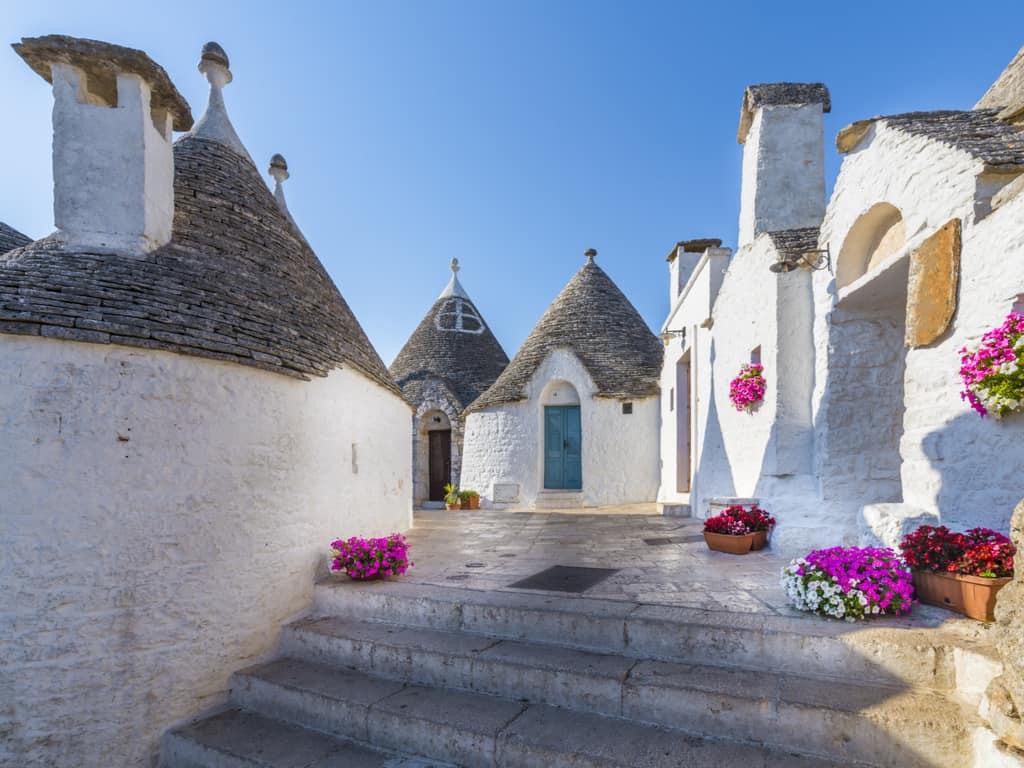 he picturesque streets of Alberobello, Italy, lined with traditional trulli houses.