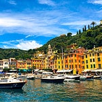 View from the sea of Portofino's idyllic coastline, with lush green hills and crystal-clear waters.
