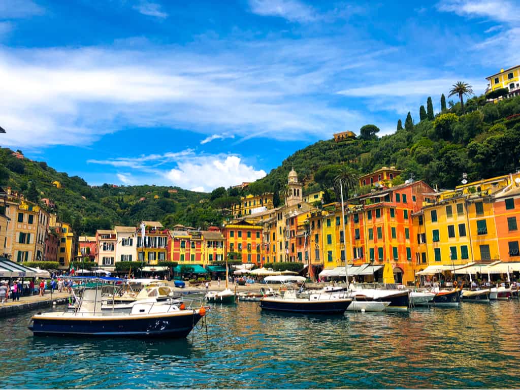 View from the sea of Portofino's idyllic coastline, with lush green hills and crystal-clear waters.