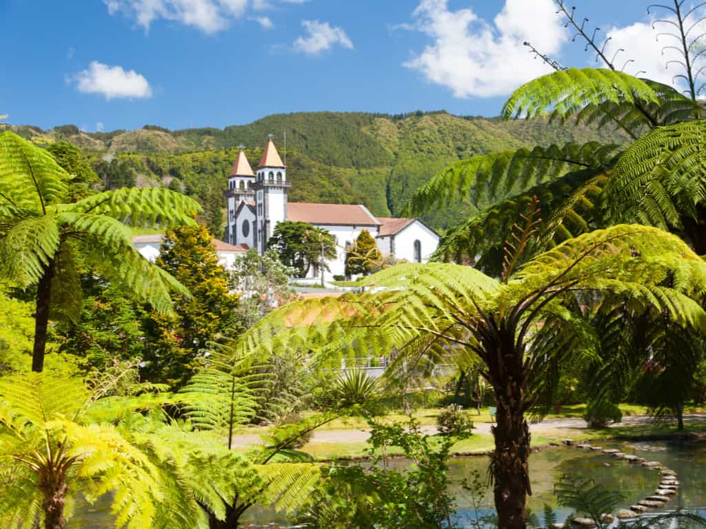 Traditional Azorean architecture with colorful houses and cobblestone streets in a quaint village.