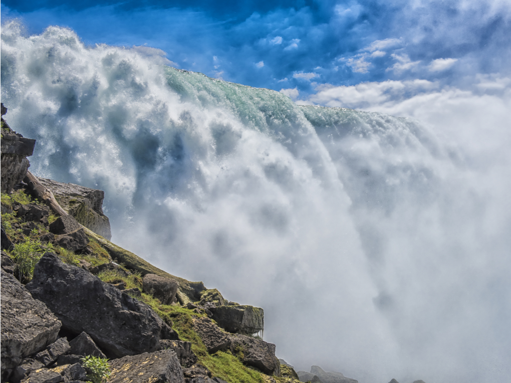 The breathtaking view of Niagara Falls with torrents of water cascading over the precipice.