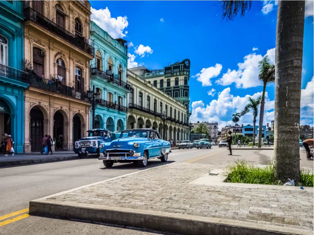 Classic American cars lining the colorful streets of Downtown Havana, Cuba.