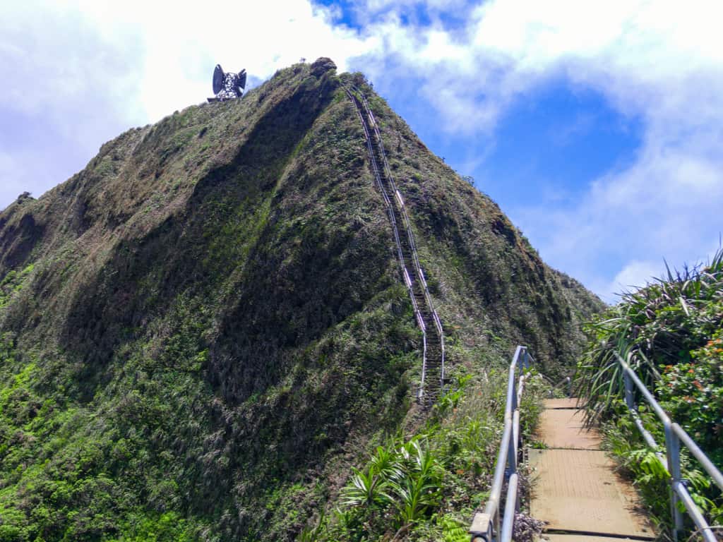 Close-up of the Haiku Stairs' metal steps against the backdrop of Hawaii's natural beauty.