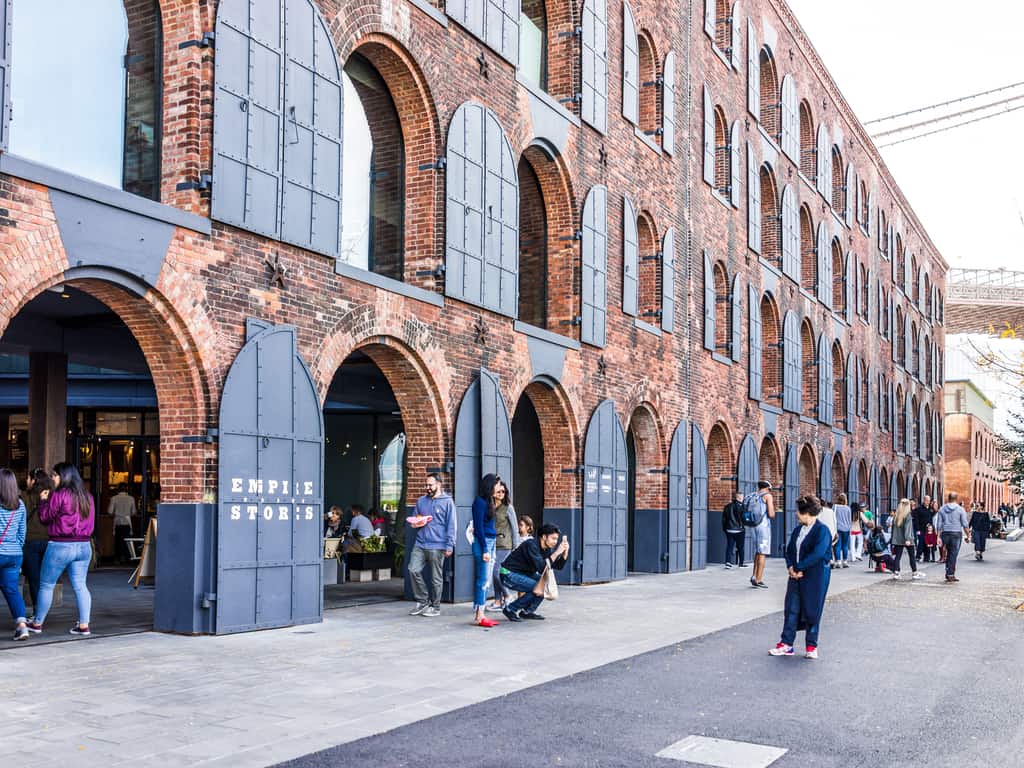 Chic cafes and boutiques lining the streets in DUMBO, reflecting the area's trendy vibe