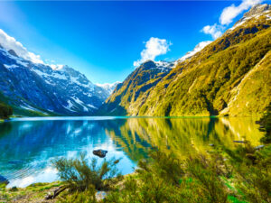Mirror Lakes reflecting the stunning scenery of Fiordland, a peaceful and picturesque spot.