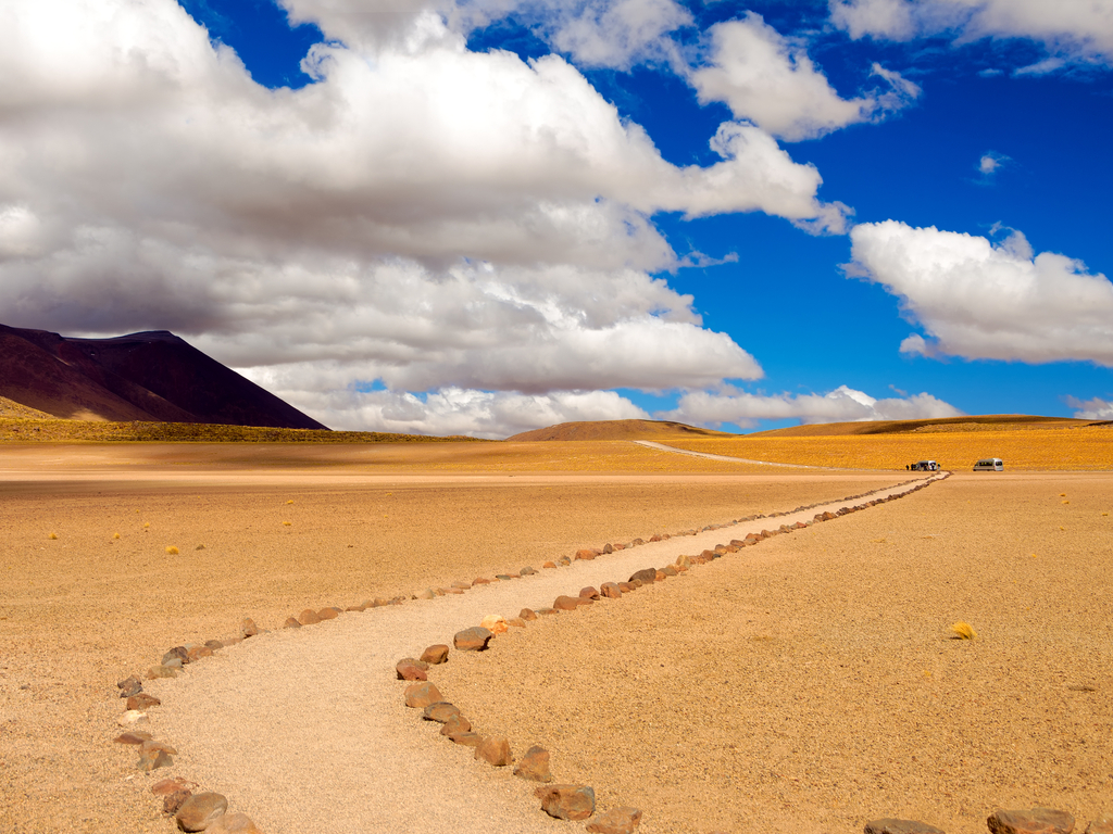 The vast, arid expanse of the Atacama Desert under a clear blue sky, embodying tranquility.